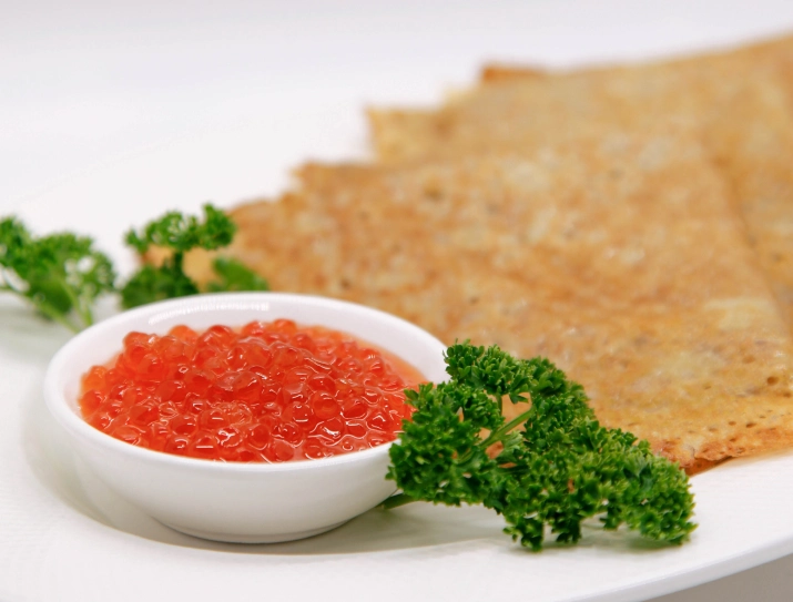 Red caviar served with Eastern European blinis